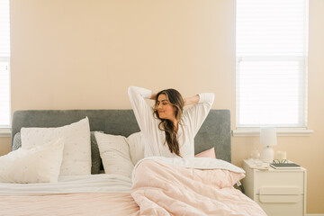 Woman gratefully waking up from bed
