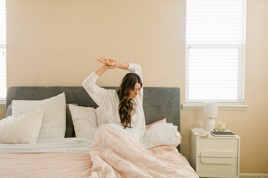 Latin woman stretching in bedroom