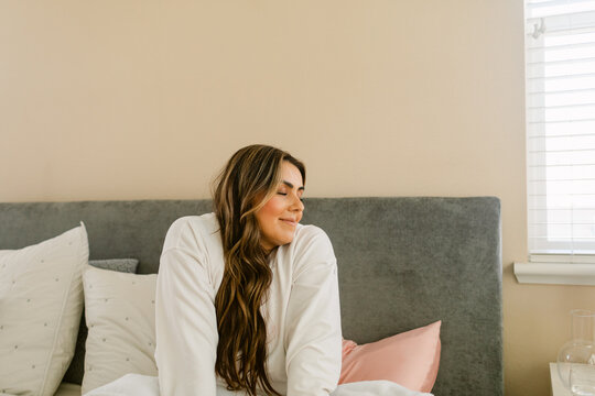 Relaxed woman in bed during morning time