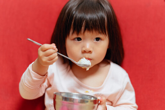 Cute little girl eats by herself