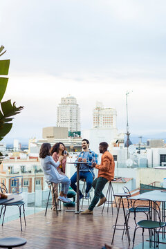 Happy diverse group having fun on terrace