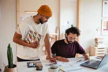 Multiracial coworkers analyzing papers together