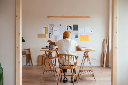 Unrecognizable male designer picking pencil