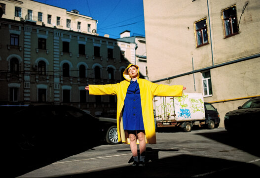 A girl in a yellow and blue raincoat