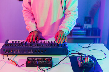 Unrecognizable male person playing synthesizer