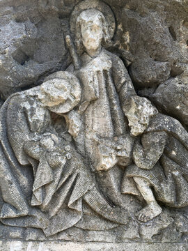 decayed religious figures in stone