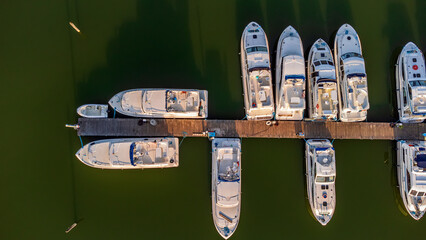 Aerial view of leisure Boats at the harbor on the river Sile (Casier, Italy) at sunset