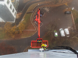 5G network installation, technicians work on a building using the lift