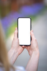 Woman holding smartphone with modern frameless design and blank screen. Close up