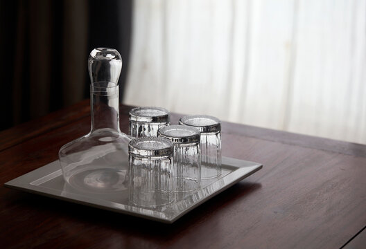 Transparent crystal cup set on wooden table

