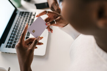 Crop woman reading credit card credentials