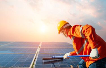 Professional worker cleaning on top of solar panels. male employee maintenance panels collect solar...