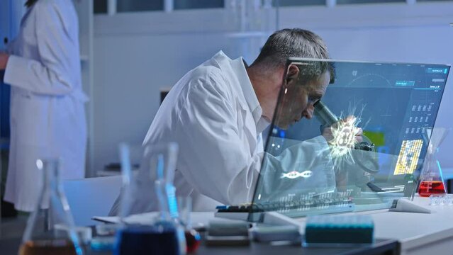 Virology lab worker examining virus cell under microscope, epidemic prevention - Powered by Adobe