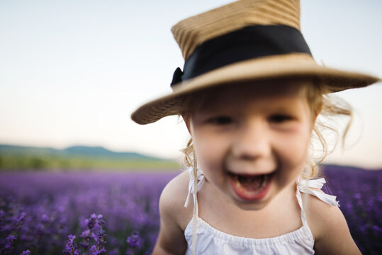 Portrait of gleeful little girl in blooming lavender field