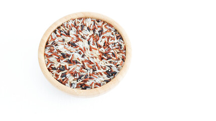 Group of mixs grains raw red, white, black and brown rice in a wooden bowl isolated on white background, dry seeds peeled, asian healthy food eating