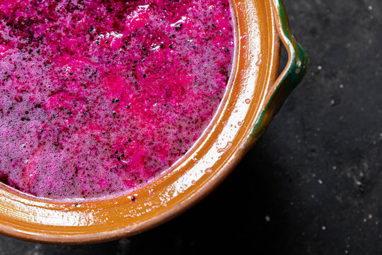 red prickly pear fermentation inside a clay pot  on the left corner
