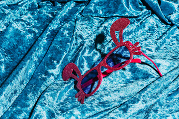 bunny-shaped eyeglasses on blue velvet