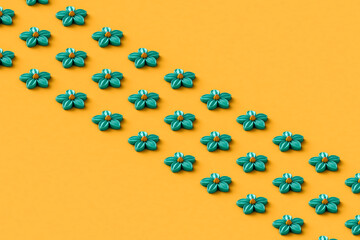 rows of blue abstract flowers on a yellow background