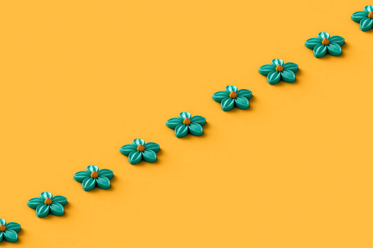 blue flowers in a row on orange background. 3d render