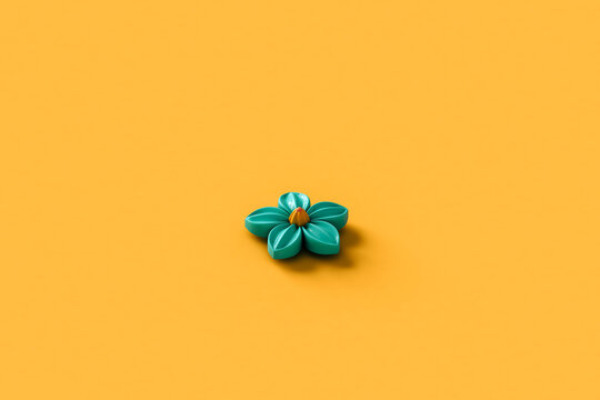 a blue abstract flower on a yellow background
