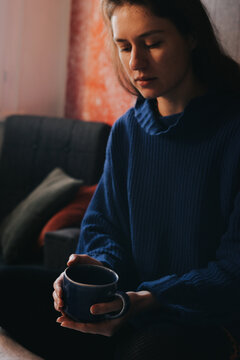 Pensive woman with a couple of tea