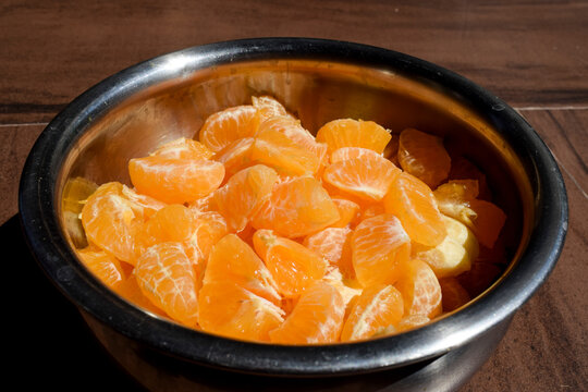 Slices of orange peeled completely and chopped and cut to make orange juice or orange fruit salad. Cut malta, mosambi, santra in container