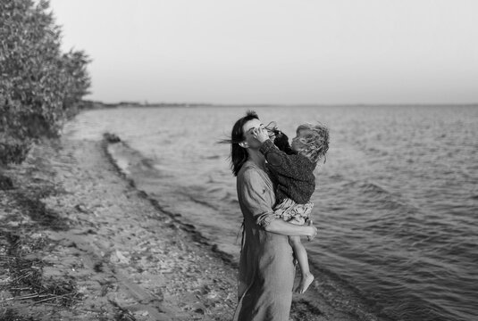 mother and daughter walking by the river