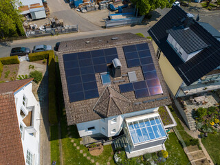 Aerial drone view of solar/photovoltaic panels on a houses roof top, Frankfurt Germany Spring