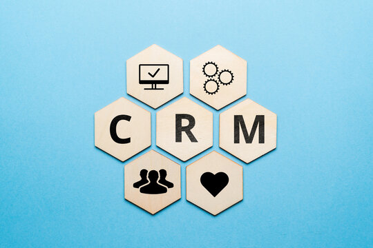 Customer relationship management or CRM. Icons on wooden cubes