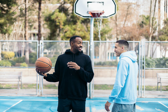 Basketball players on an outdoor court