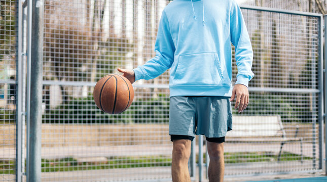 Anonymous man bouncing a basketball ball