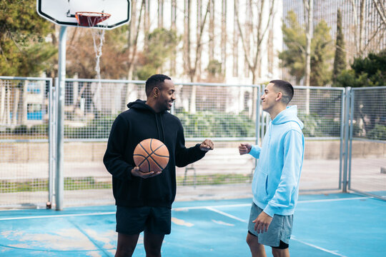 Basketball players on an outdoor court