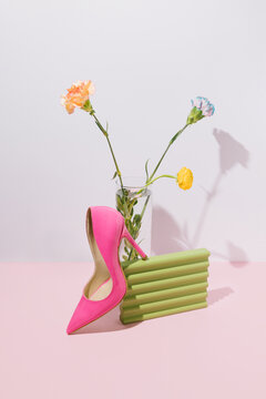 Female sandal, green zig-zag object, and yellow flower.
