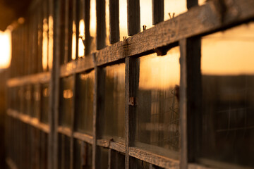 Window of an old house in sunset. Close up