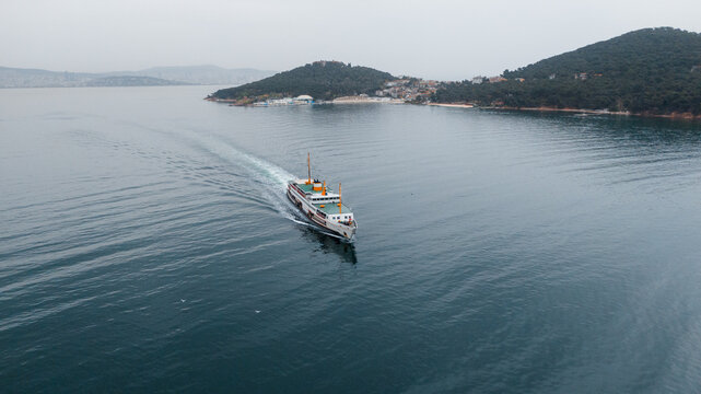 drone photo of a ferry passing by Prince Islands in Turkey