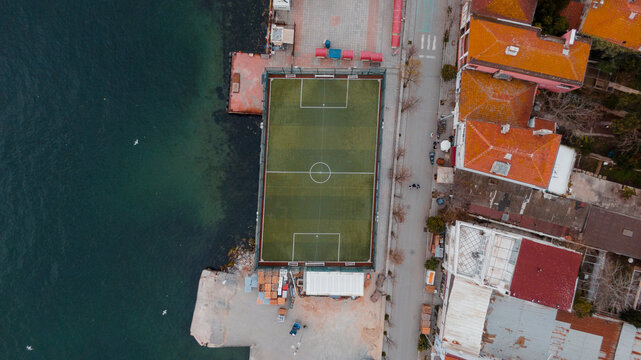 Aerial shot of a football playground by the sea