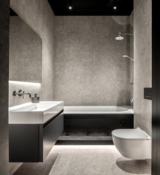 Interior of illuminated bathroom with tiled walls
