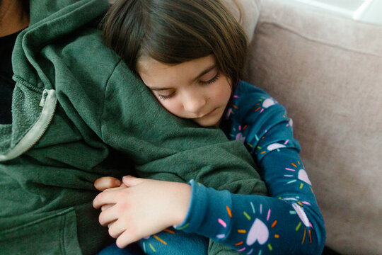 girl hugs father's arm