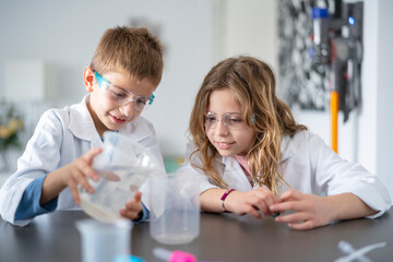 Siblings playing science