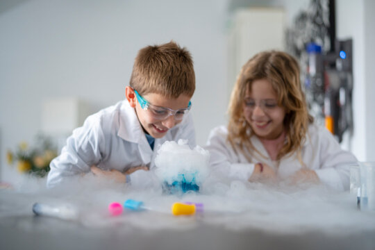 Happy children watching smoke emission process
