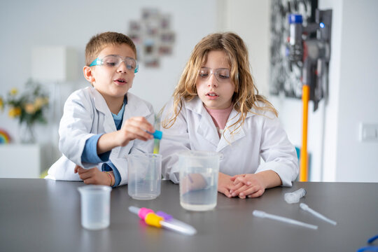 Kids conducting chemical experiment at home