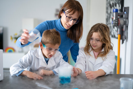 Children and mother conducting an experiment at home