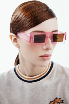 Fashion portrait of a young woman in pink glasses