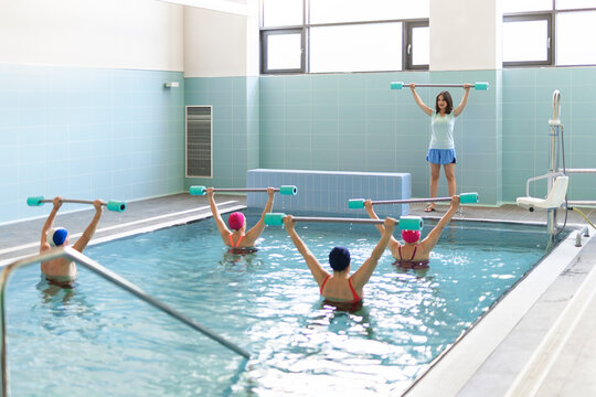 Senior people exercising in pool
