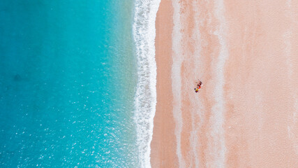 Fototapeta premium abstract aerial photo of a sea coast and a couple on the beach