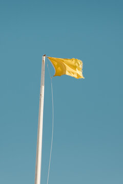 Yellow Beach Safety Flag with Blue Sky 
