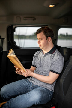 Man with down syndrome reading a book