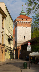 Pijarska street with Kraków Defensive Walls and St. Florian's Gate or Florian Gate (Brama Floriańska). Gothic tower, part of historic fortifications in the Old Town of Krakow, Poland.