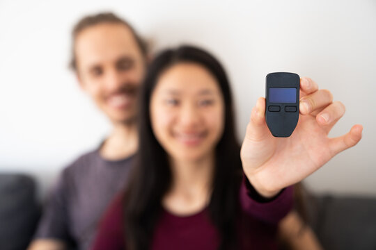 Couple Holding Cold Wallet For Crypto
