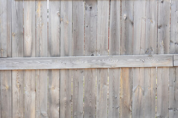 Wooden fence made of old gray pine wooden planks